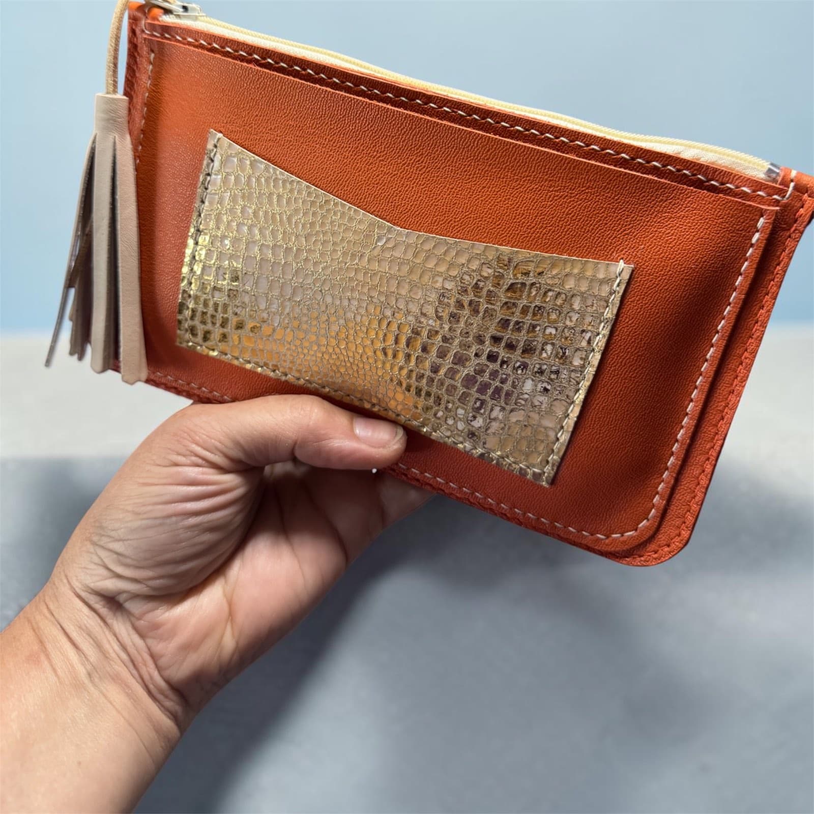 Pochette zippée en cuir orange