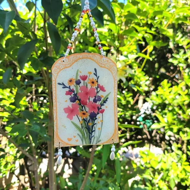 Détail de l'illustration florale aux nuances roses, violettes et jaunes sous résine transparente
