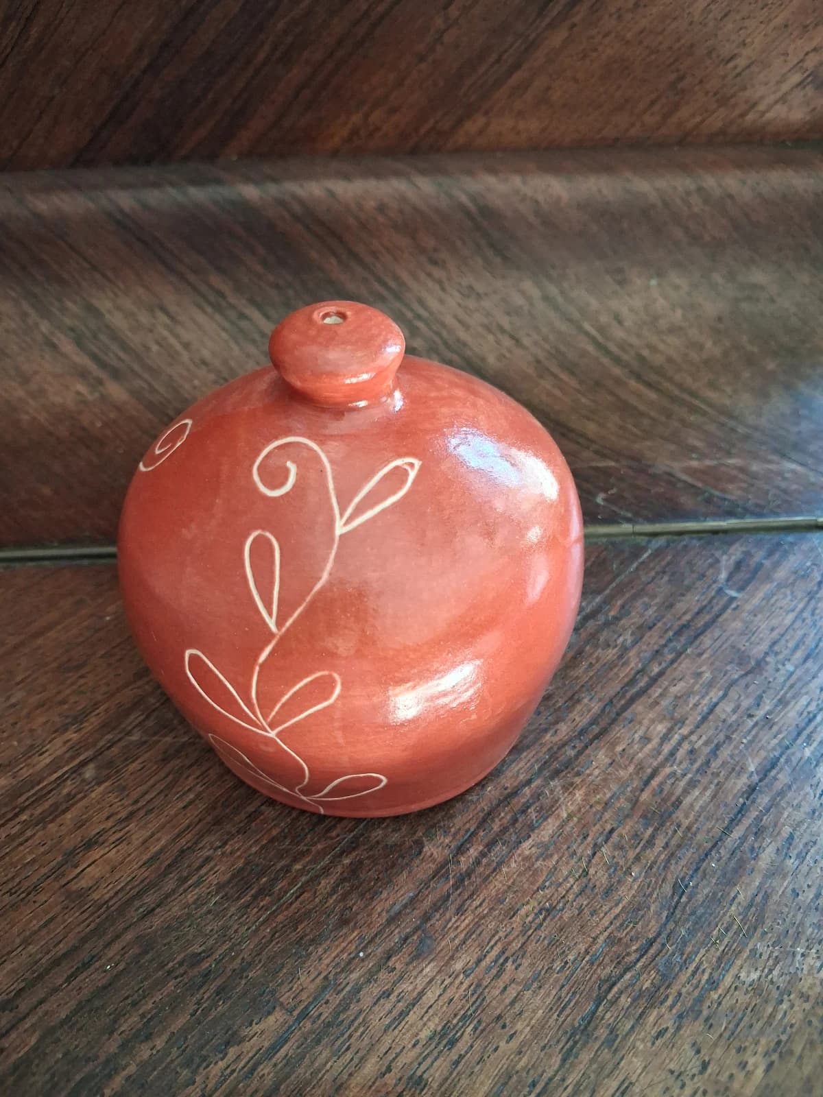 Arrosoir-main en céramique rouge brique à motif végétal